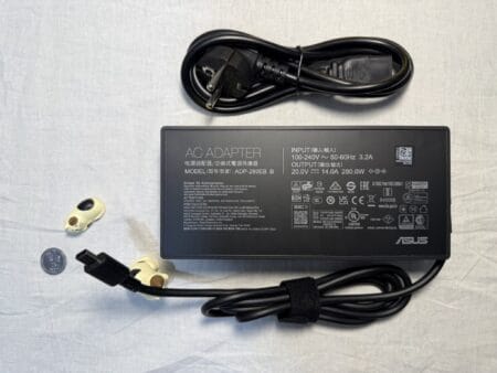 ASUS laptop charger, 280W 20V 14A, with a rectangular connector. Shown with the power cord; the front side of the charger features a sticker containing the device's specifications. 