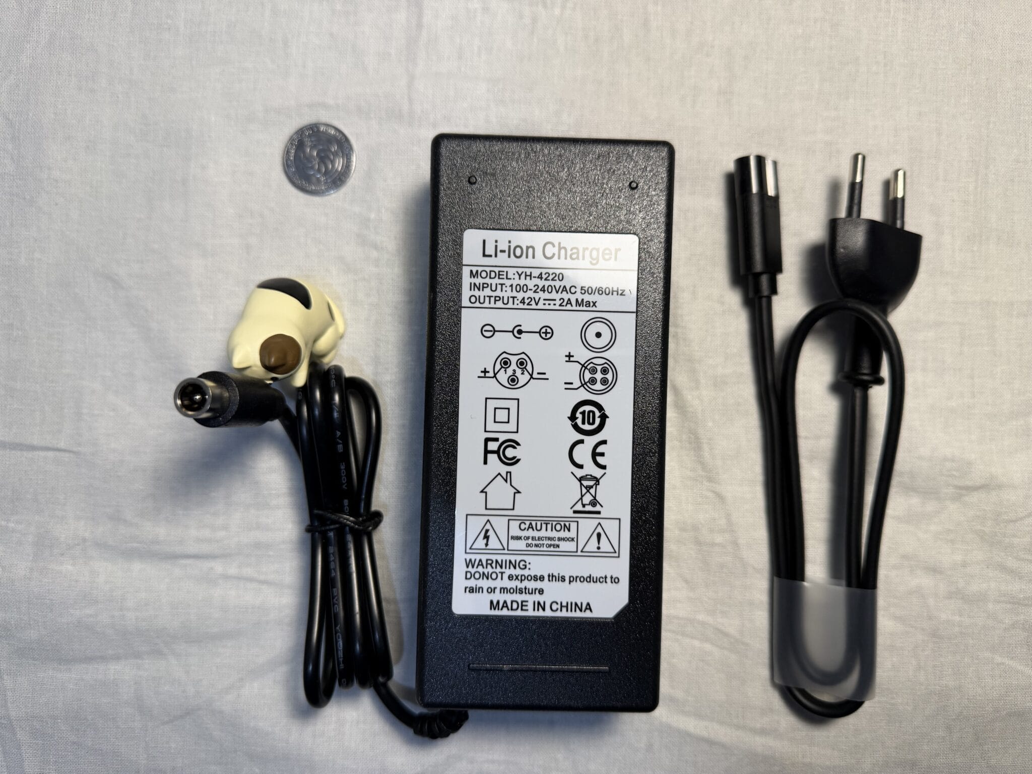 IMG_5622 Electric scooter charger 42V 2A 84W RCA 8mm – front side, showing the charger sticker